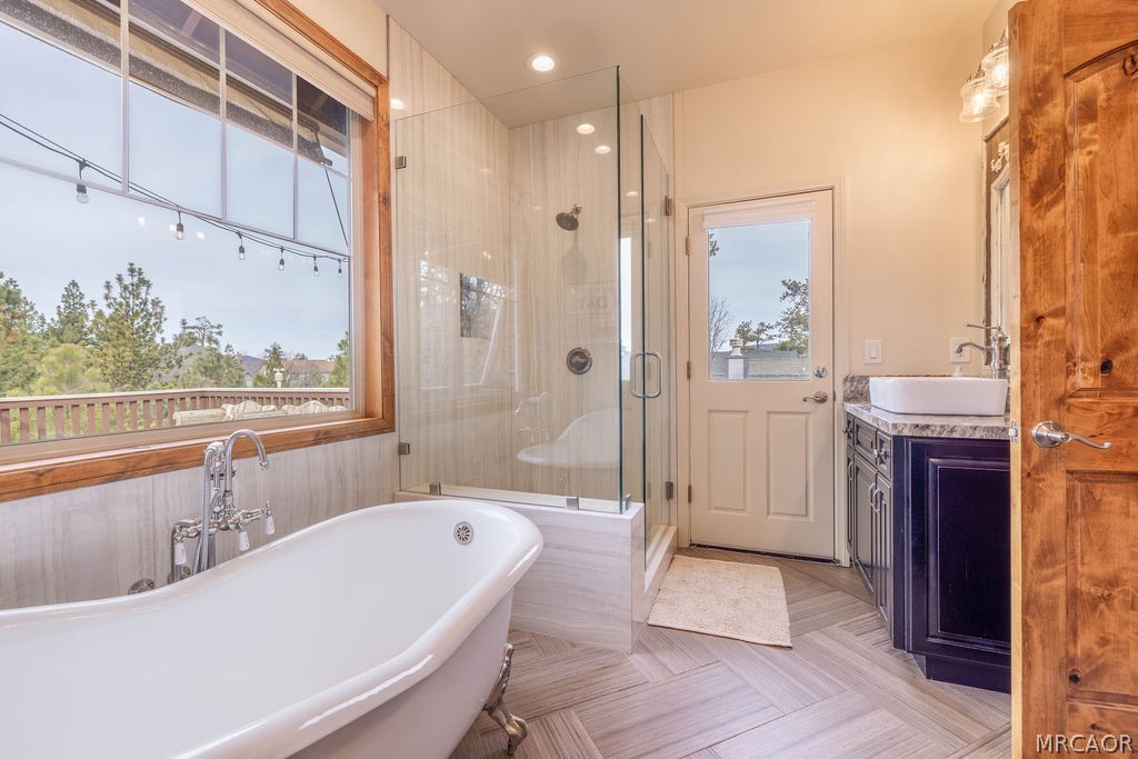 1629 Angels Camp Road Big Bear City, CA 92314 - Photo 17 of 40 a bathroom with a large tub a sink and shower