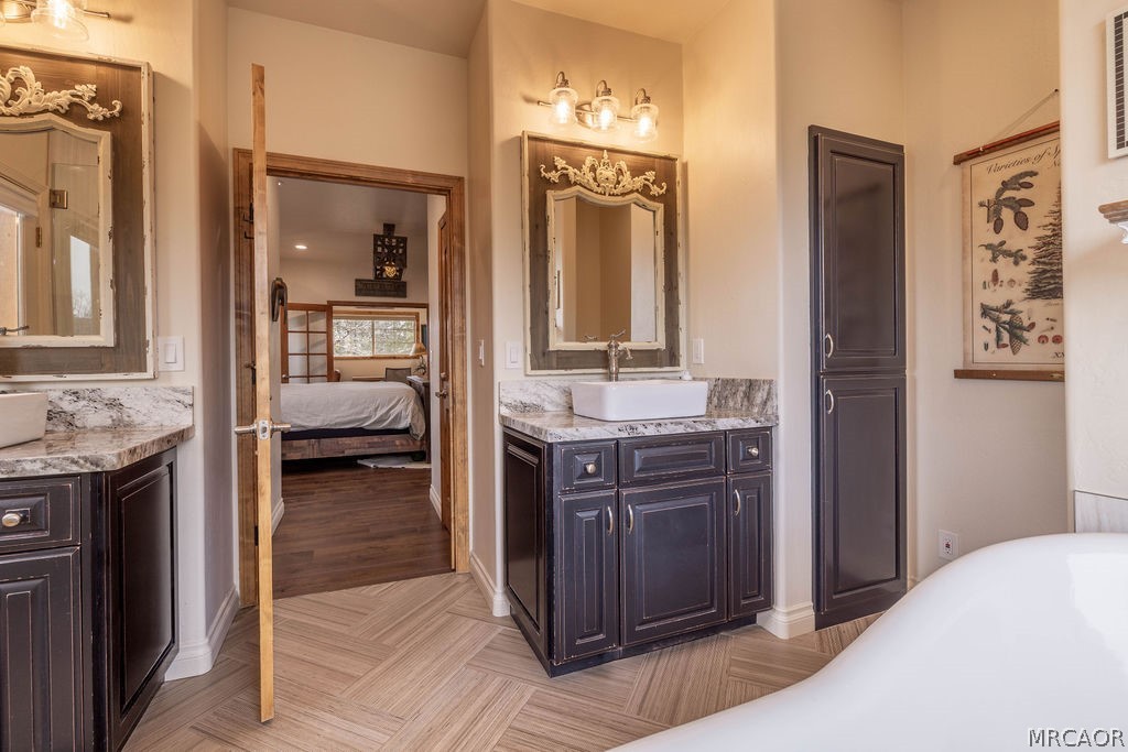 1629 Angels Camp Road Big Bear City, CA 92314 - Photo 18 of 40 a en suite bathroom with a granite countertop sink and a mirror