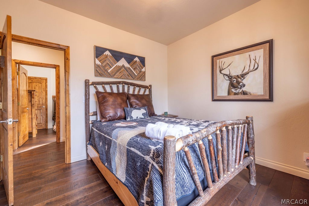 1629 Angels Camp Road Big Bear City, CA 92314 - Photo 22 of 40 a bedroom with a bed and a painting on the wall