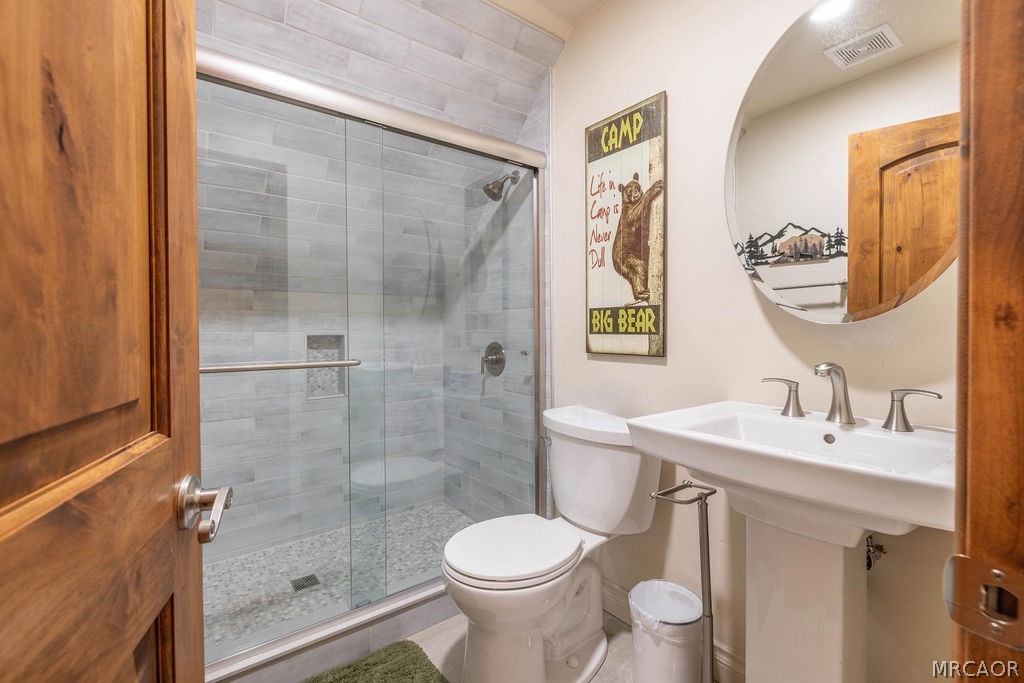 1629 Angels Camp Road Big Bear City, CA 92314 - Photo 26 of 40 a bathroom with a sink toilet and shower