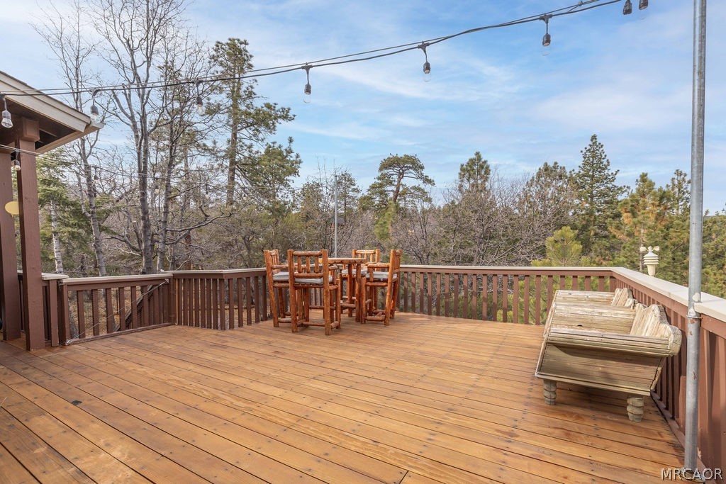 1629 Angels Camp Road Big Bear City, CA 92314 - Photo 28 of 40 a view of a balcony with wooden floor and outdoor seating