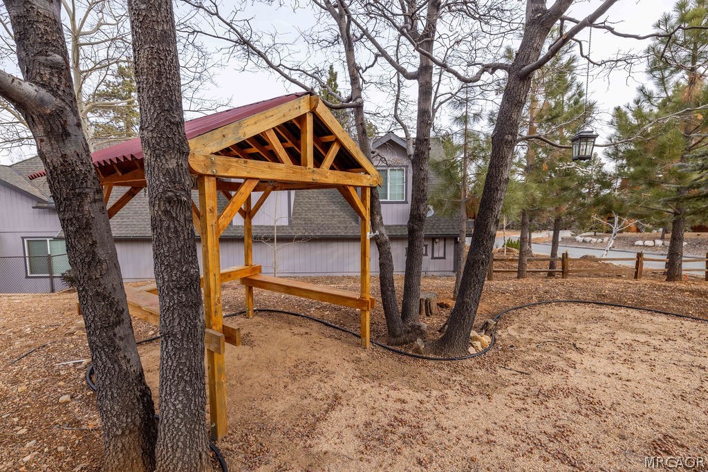 1629 Angels Camp Road Big Bear City, CA 92314 - Photo 30 of 40 a backyard of a house with lots of trees