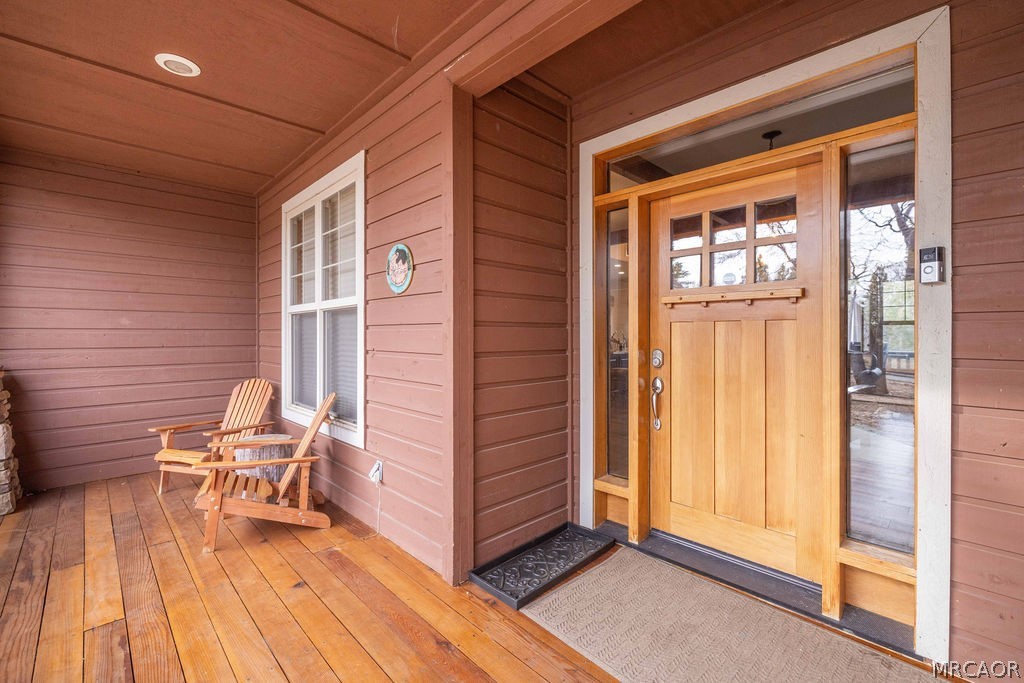 1629 Angels Camp Road Big Bear City, CA 92314 - Photo 6 of 40 a porch with seating space and a wooden floor