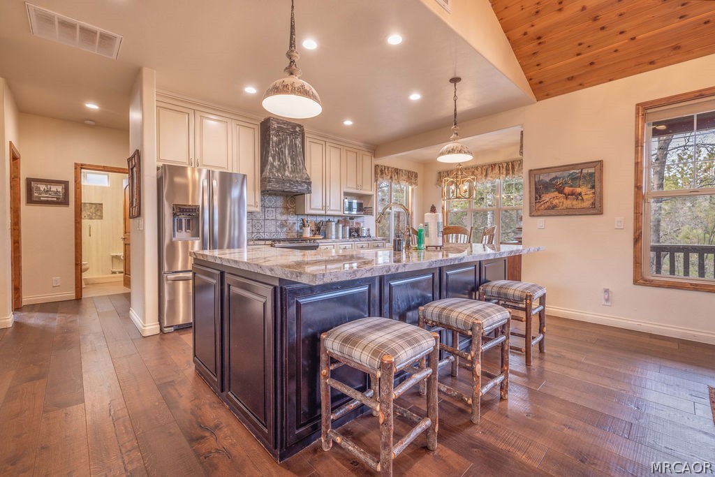 1629 Angels Camp Road Big Bear City, CA 92314 - Photo 10 of 40 a kitchen with stainless steel appliances granite countertop wooden floor cabinets dining table and chairs