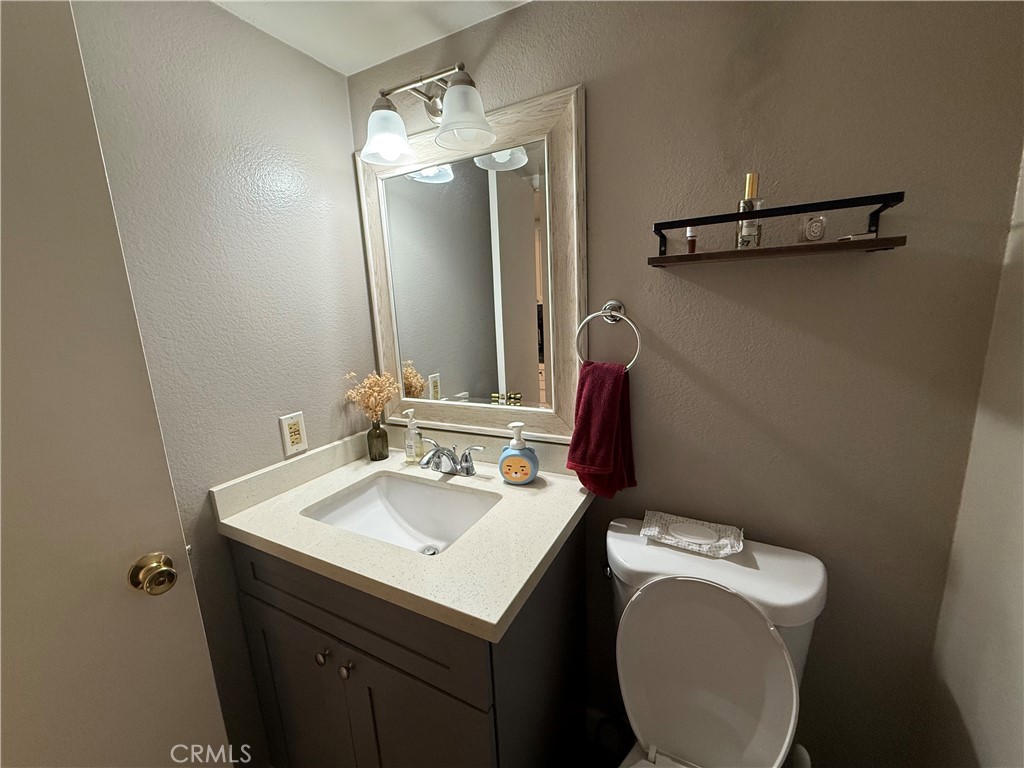 2201 Cheyenne Way, Unit 125 Fullerton, CA 92833 - Photo 13 of 30 a bathroom with a sink vanity mirror and toilet