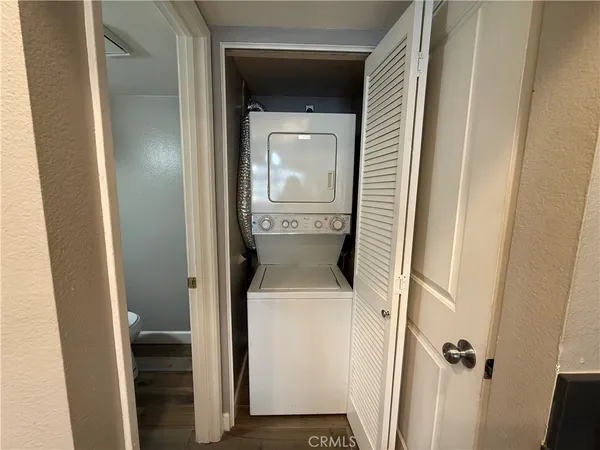 a room with a mirror and a wooden floor