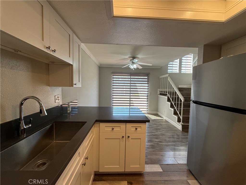 2201 Cheyenne Way, Unit 125 Fullerton, CA 92833 - Photo 15 of 30 a kitchen with kitchen island a sink appliances and cabinets