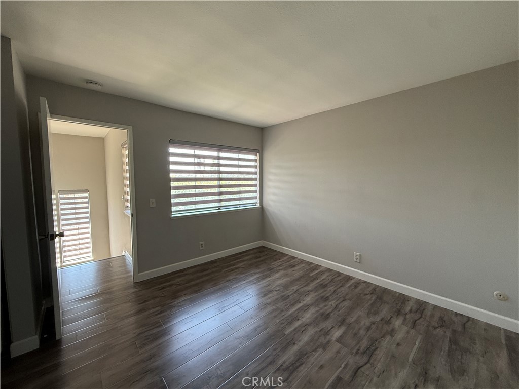 2201 Cheyenne Way, Unit 125 Fullerton, CA 92833 - Photo 20 of 30 a view of an empty room with wooden floor and a window