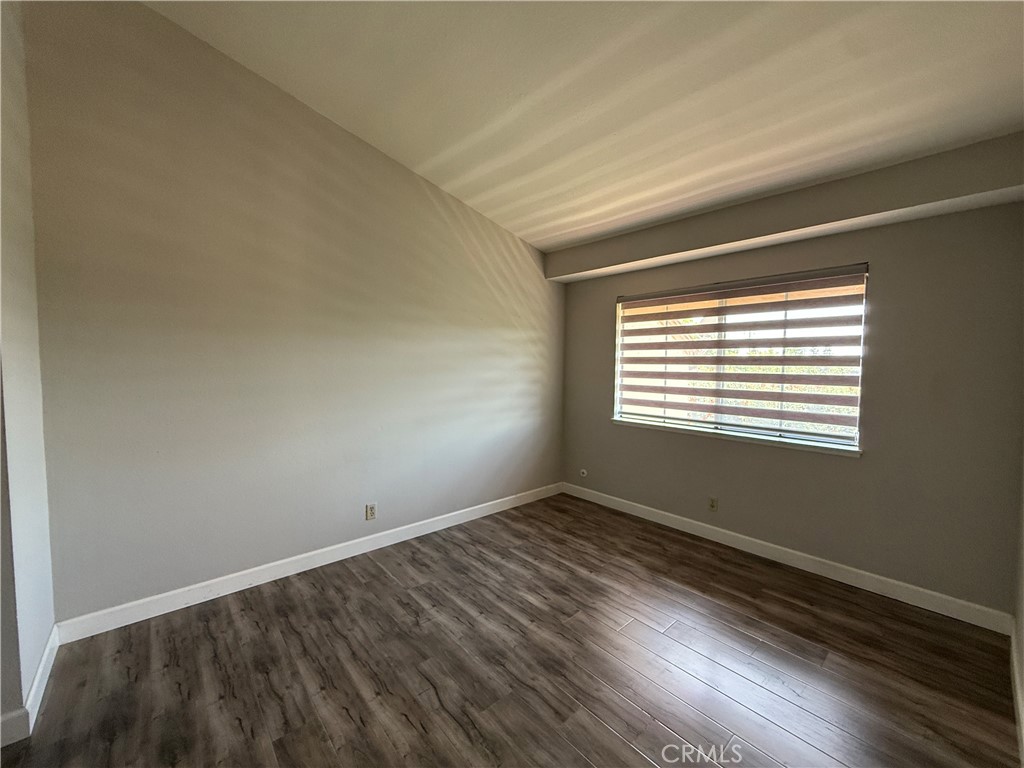 2201 Cheyenne Way, Unit 125 Fullerton, CA 92833 - Photo 23 of 30 a view of an empty room with wooden floor and a window