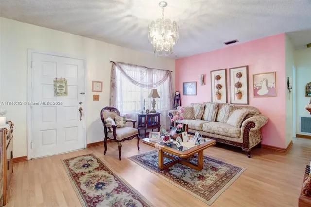 a living room with furniture and a chandelier