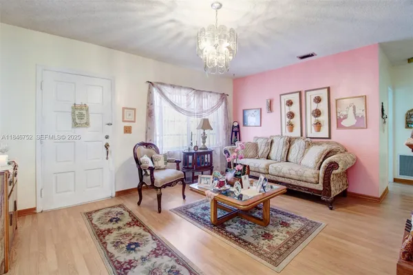a living room with furniture and a chandelier