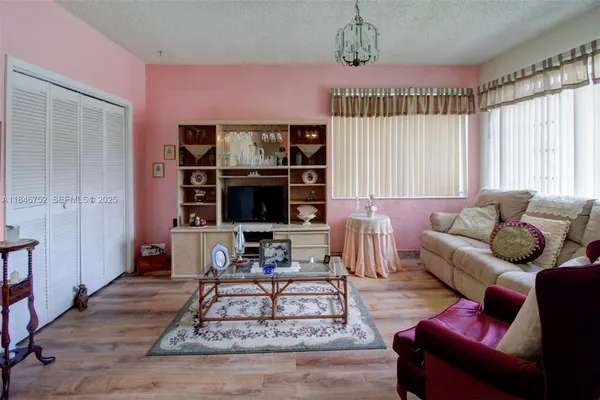 a living room with furniture a rug and a window