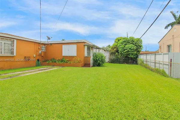 a view of a house with a yard and garage