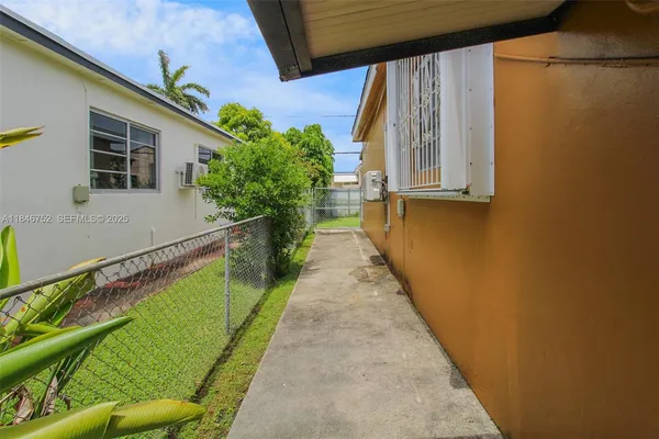 a view of a backyard with potted plants