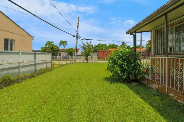 a view of a backyard with potted plants
