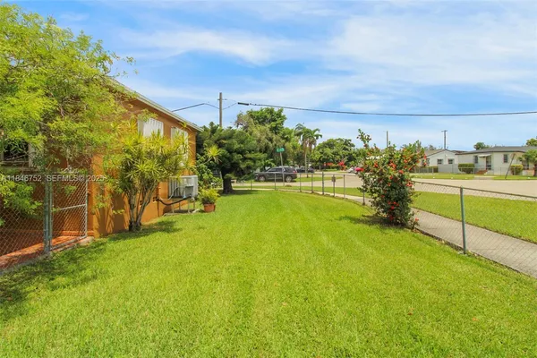 a view of a yard with an outdoor seating