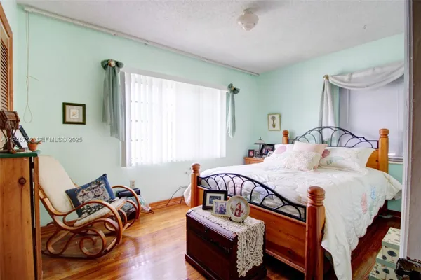 a bedroom with bed and a couch