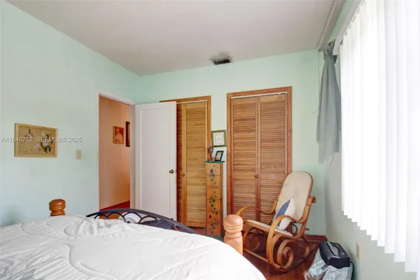 a bed room with a bed and a chair