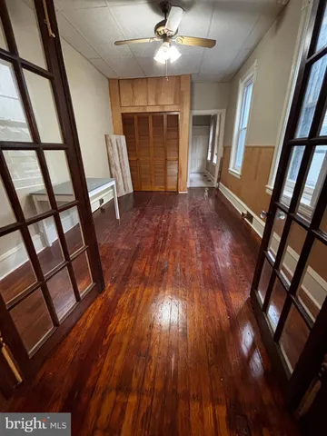 wooden floor in an empty room with a window