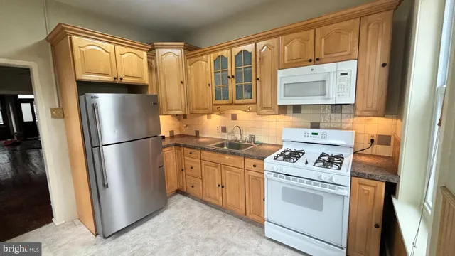 a kitchen with a refrigerator stove and sink