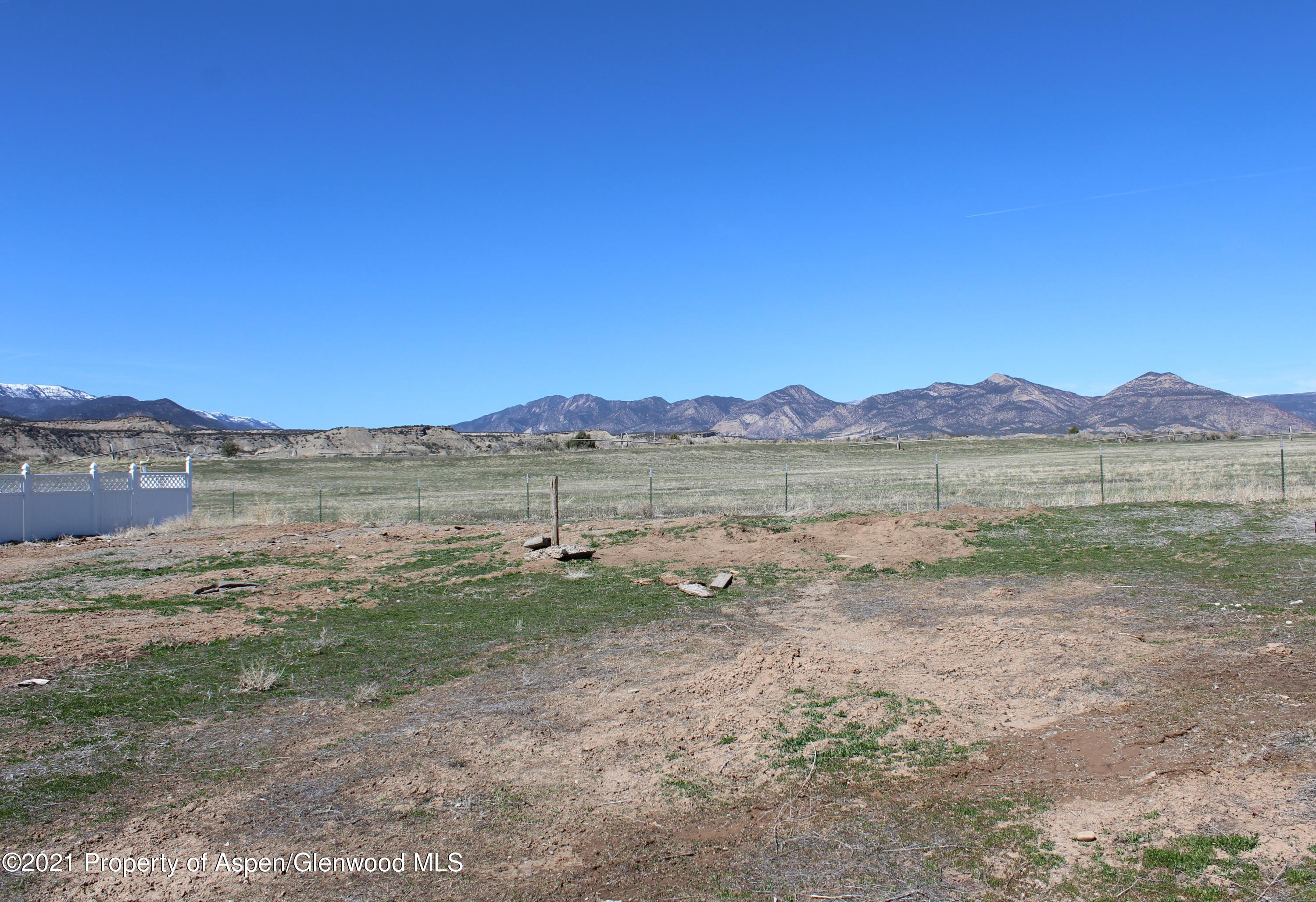 818 East 19th Street Rifle, CO 81650 - Photo 2 of 5 a view of a lake with mountain in the background