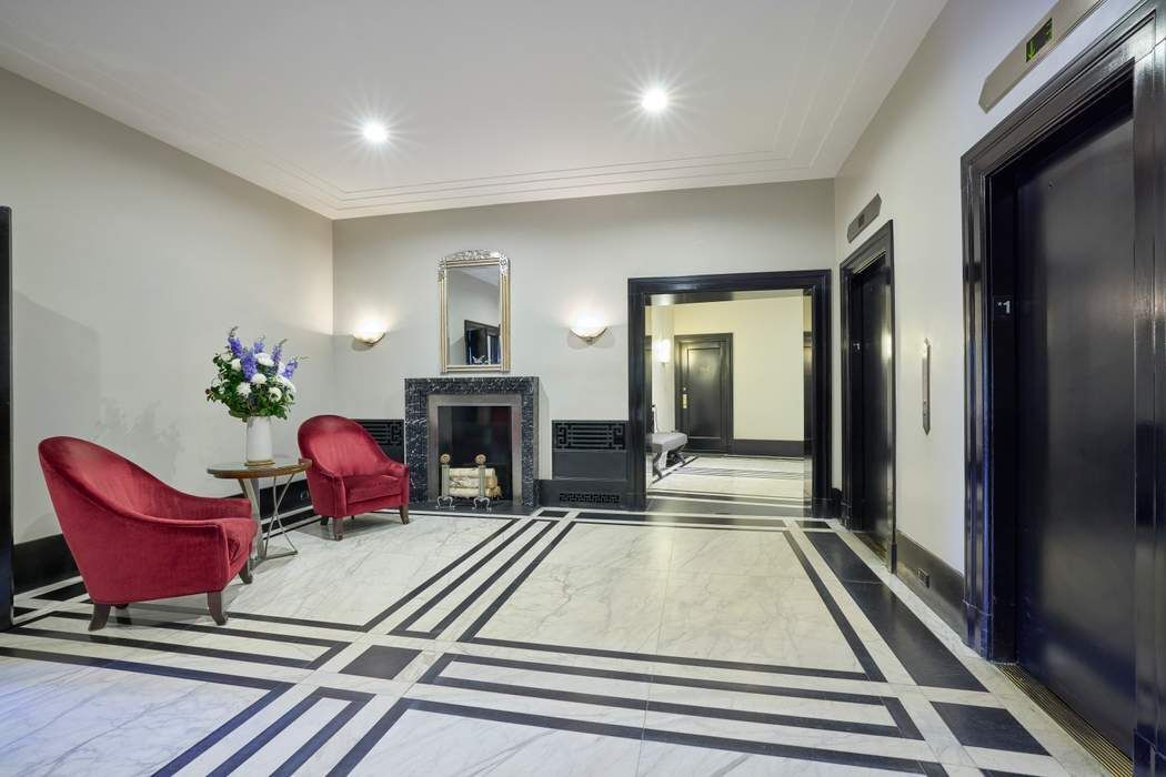 5 Riverside Drive, Unit 12C Manhattan, NY 10023 - Photo 11 of 12 a living room with furniture and a fireplace