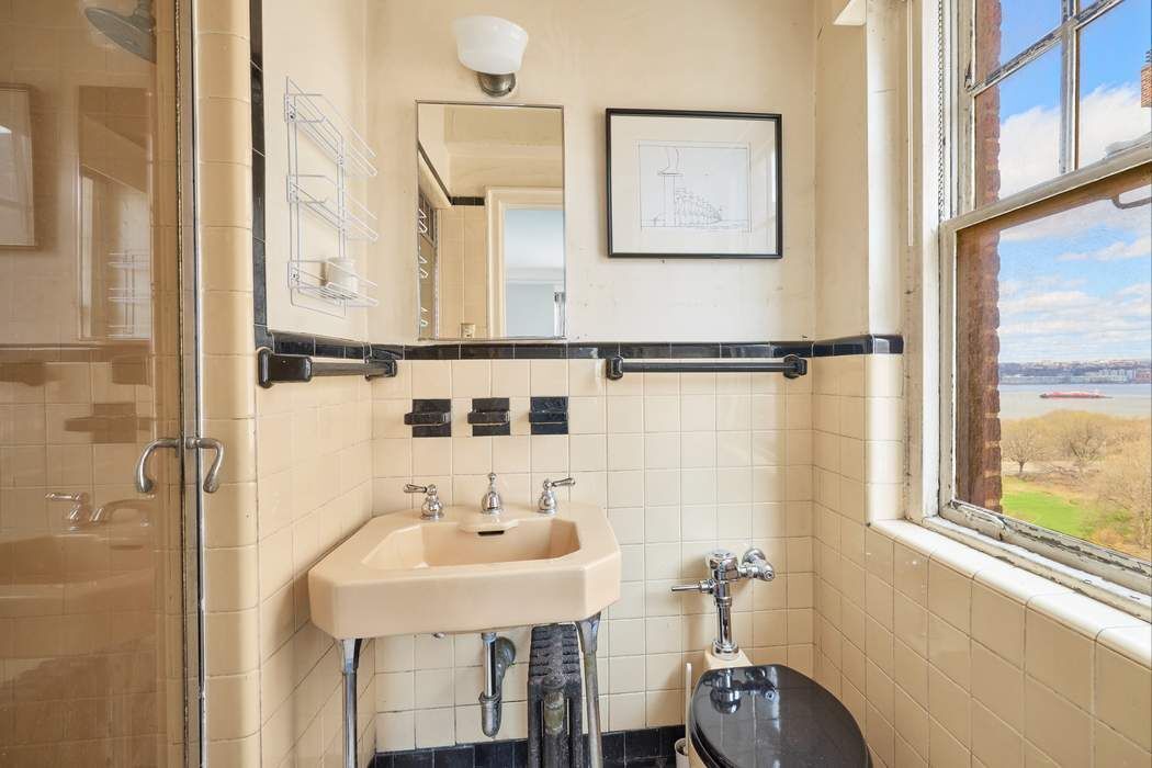 5 Riverside Drive, Unit 12C Manhattan, NY 10023 - Photo 9 of 12 a bathroom with a sink and a mirror