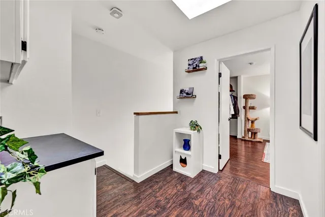 a view of a hallway with wooden floor and stairs