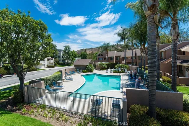 a view of a patio with couches table and chairs and potted plants