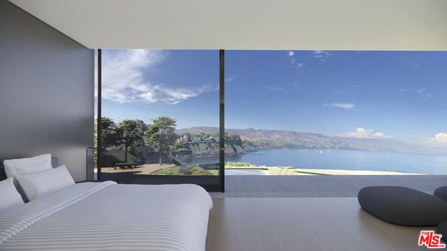 a bedroom with a large window and a bed