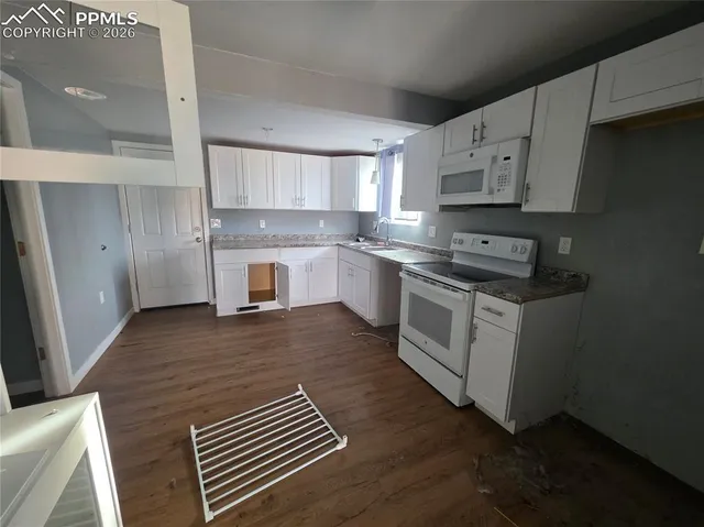 a kitchen with a stove a sink and a refrigerator