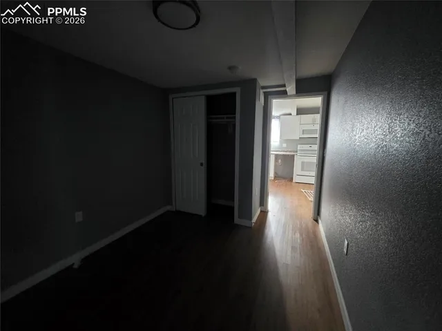 a view of hallway with wooden floor