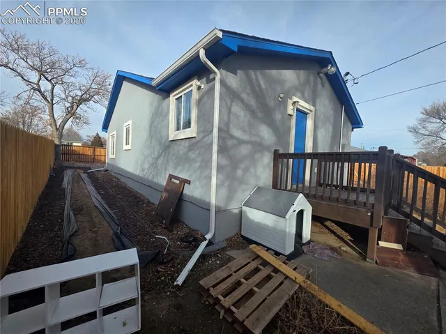 a view of backyard with deck and wooden floor