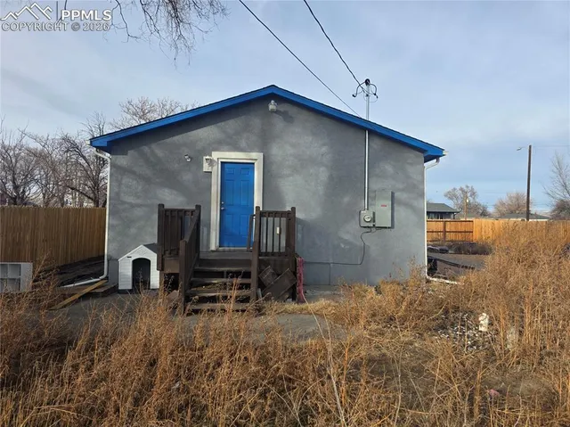 a backyard of a house with barbeque oven stove and table top oven