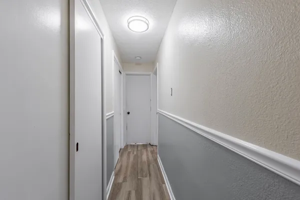 a view of hallway with wooden floor