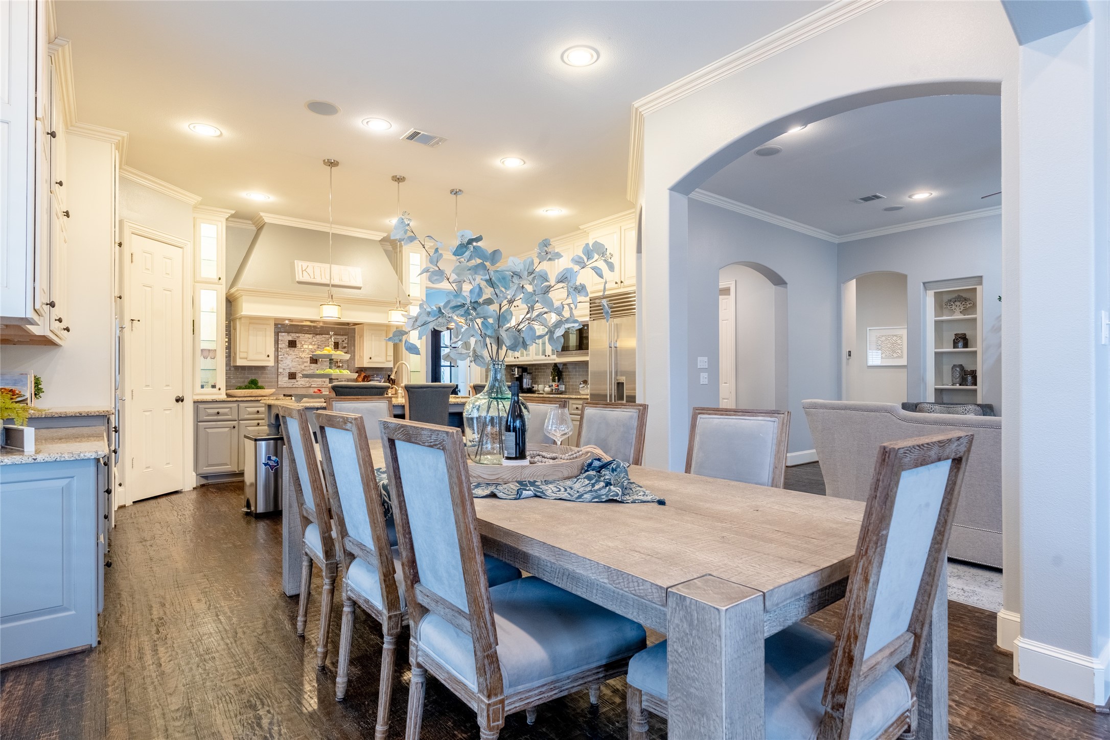 6 Rhapsody Bend Drive The Woodlands, TX 77382 - Photo 14 of 39 a view of a dining room and livingroom with furniture wooden floor a rug a painting and a chandelier