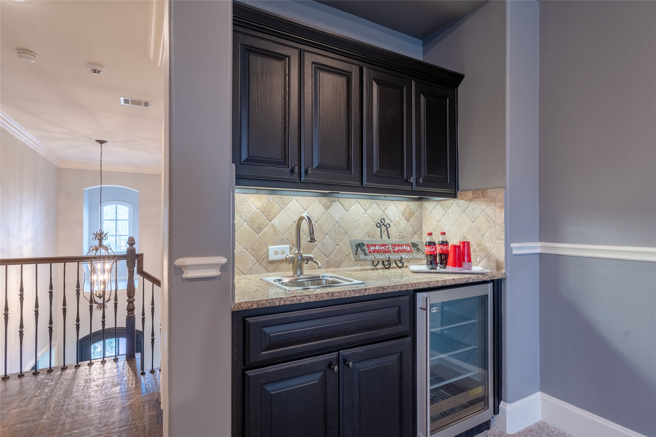 6 Rhapsody Bend Drive The Woodlands, TX 77382 - Photo 25 of 39 a kitchen with a sink cabinets and wooden floor