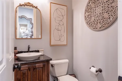 a bathroom with a toilet sink and mirror