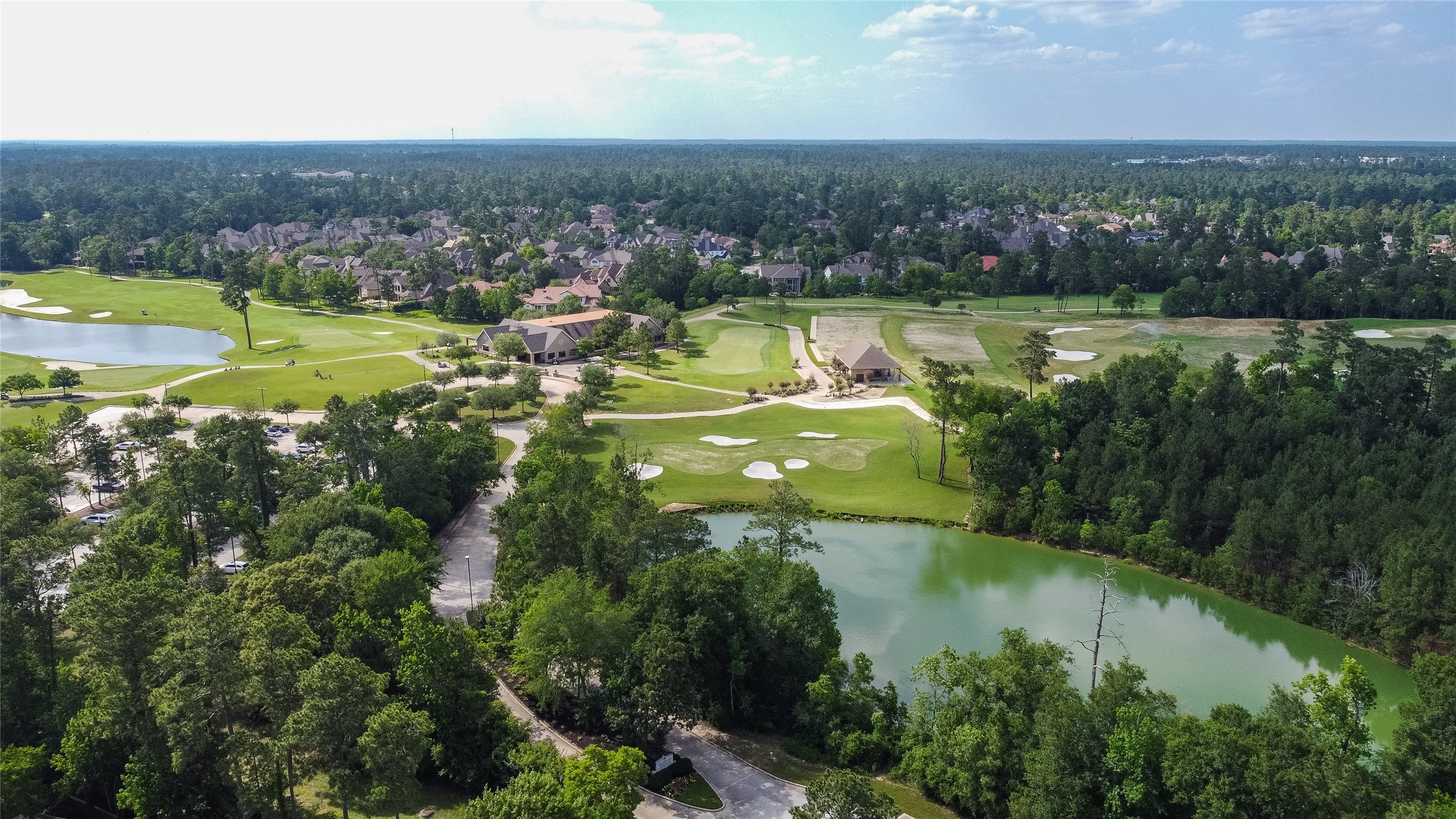 6 Rhapsody Bend Drive The Woodlands, TX 77382 - Photo 35 of 39 an aerial view of green landscape with trees houses and lake view