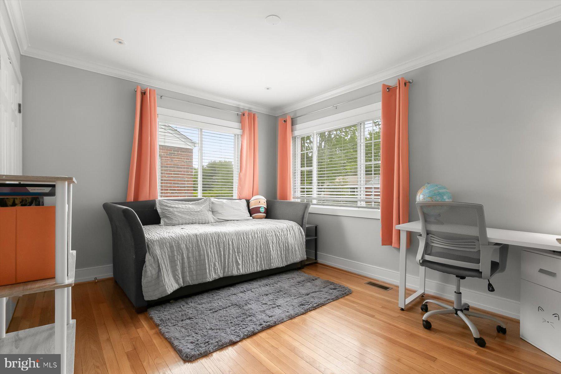 513 Gilmoure Drive Silver Spring, MD 20901 - Photo 26 of 60 a bedroom with a bed and large windows