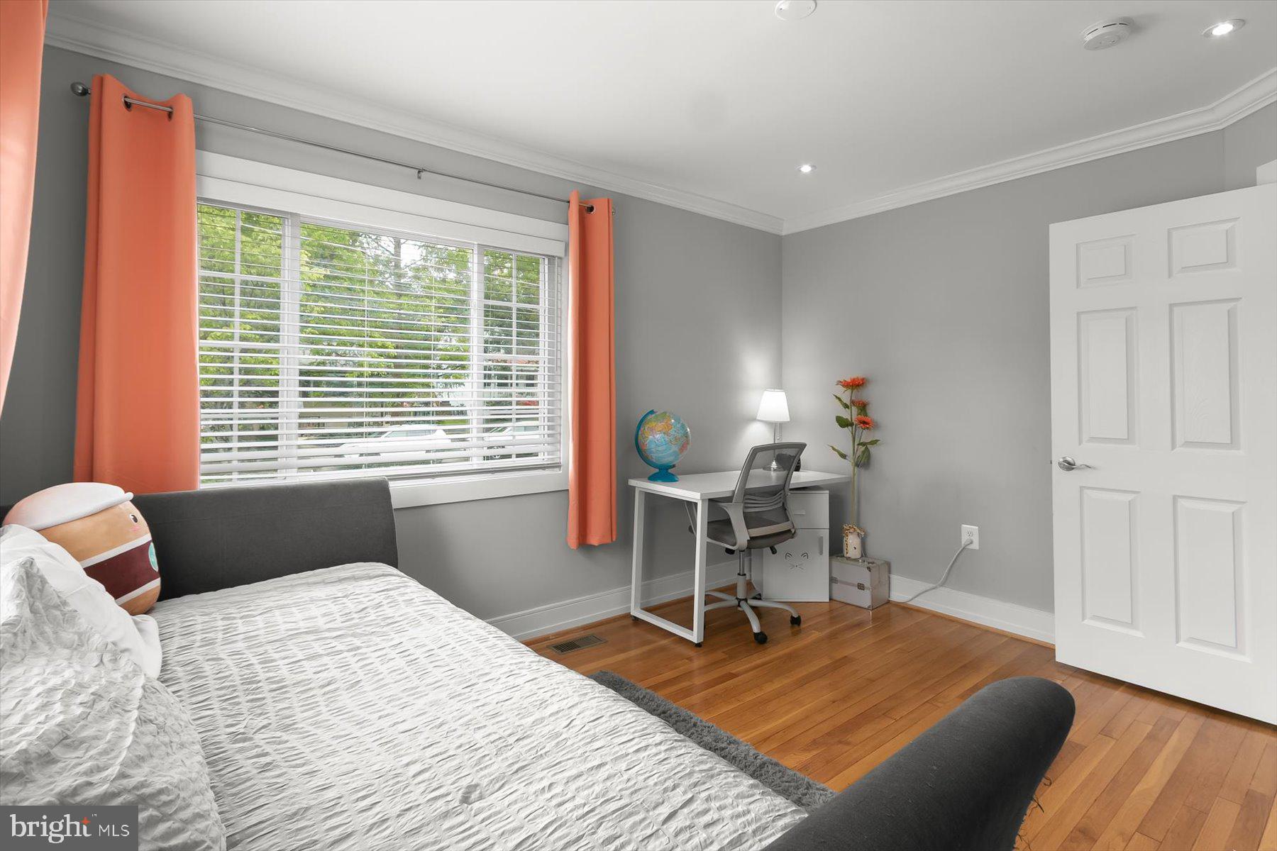 513 Gilmoure Drive Silver Spring, MD 20901 - Photo 27 of 60 a bedroom with a bed and a table in it