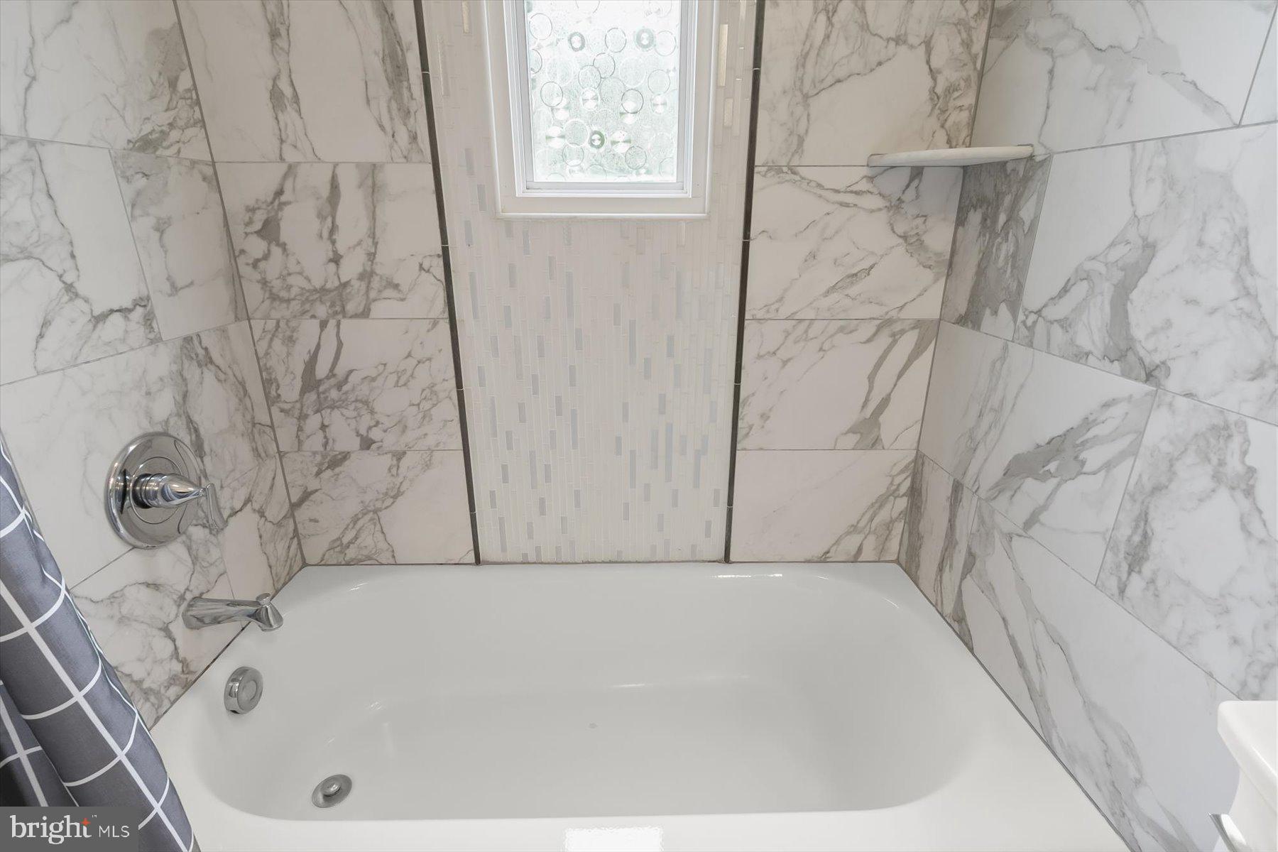 513 Gilmoure Drive Silver Spring, MD 20901 - Photo 29 of 60 a bathroom with a bathtub