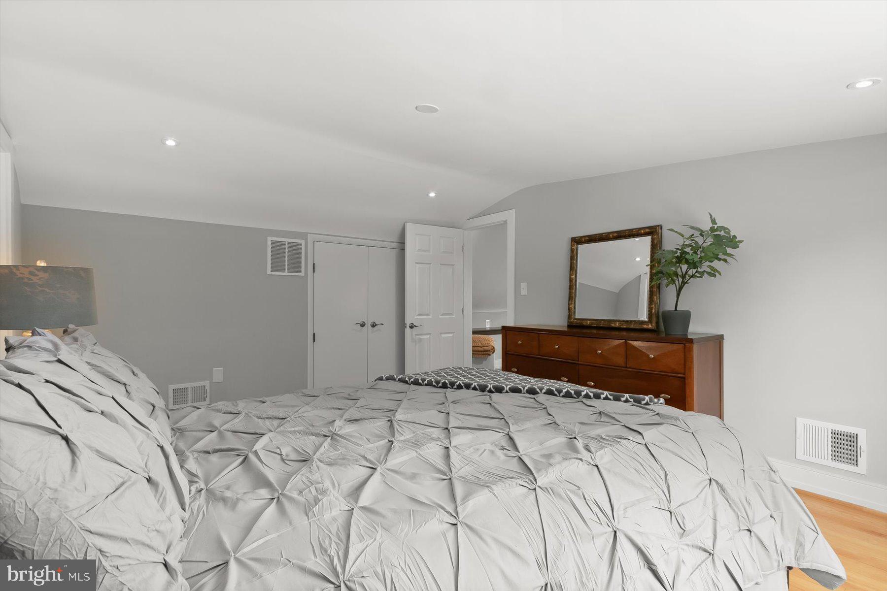 513 Gilmoure Drive Silver Spring, MD 20901 - Photo 37 of 60 a bedroom with a large bed and a potted plant
