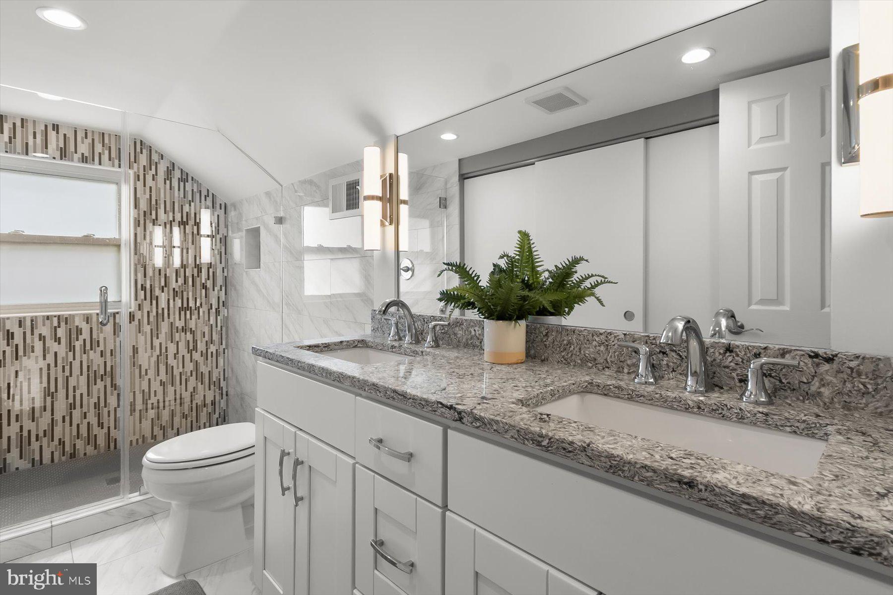 513 Gilmoure Drive Silver Spring, MD 20901 - Photo 39 of 60 a bathroom with a granite countertop sink and a mirror
