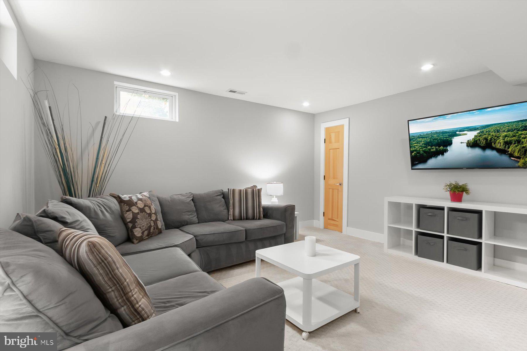 513 Gilmoure Drive Silver Spring, MD 20901 - Photo 45 of 60 a living room with furniture and a flat screen tv
