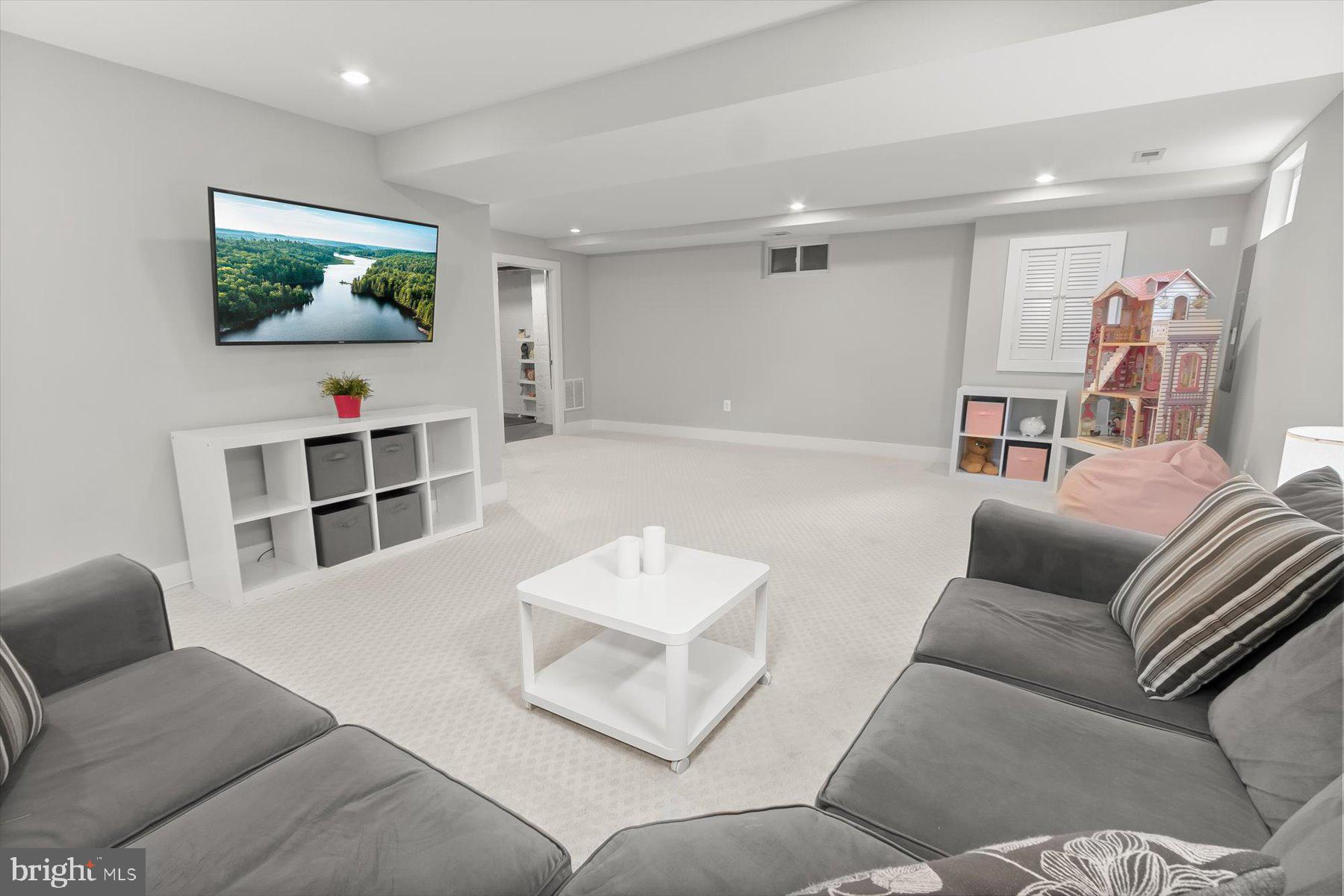 513 Gilmoure Drive Silver Spring, MD 20901 - Photo 47 of 60 a living room with furniture and a flat screen tv