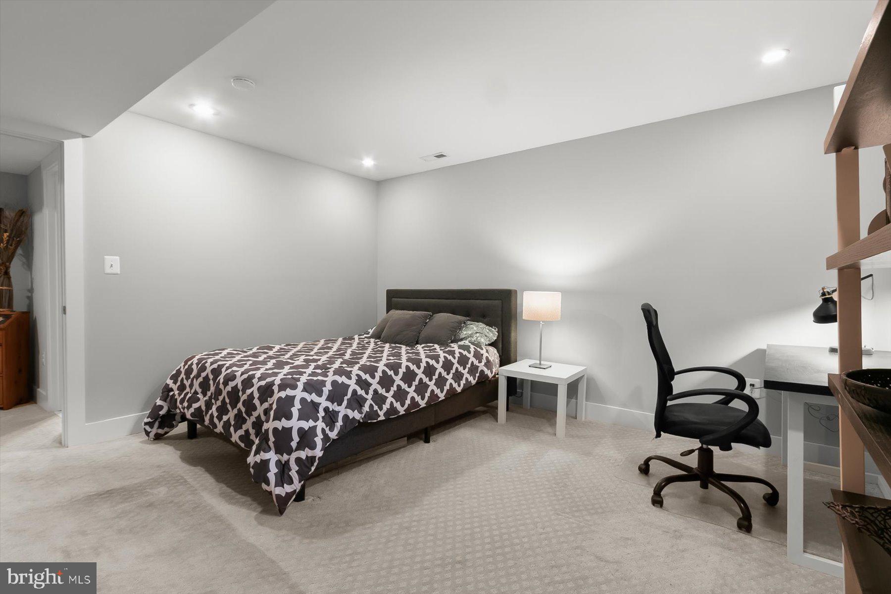 513 Gilmoure Drive Silver Spring, MD 20901 - Photo 51 of 60 a bedroom with a bed chair and white walls
