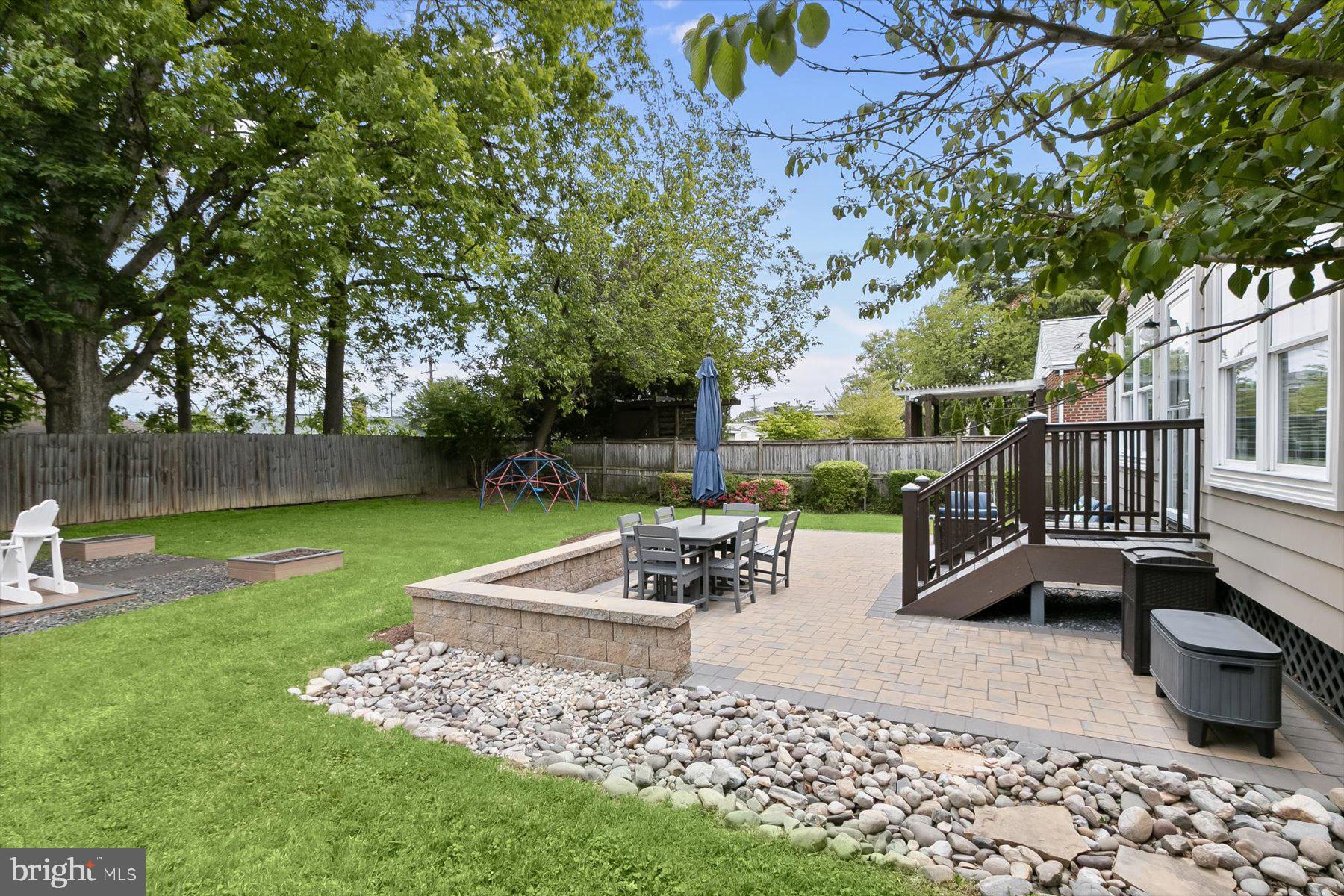 513 Gilmoure Drive Silver Spring, MD 20901 - Photo 55 of 60 a view of a patio with a table and chairs