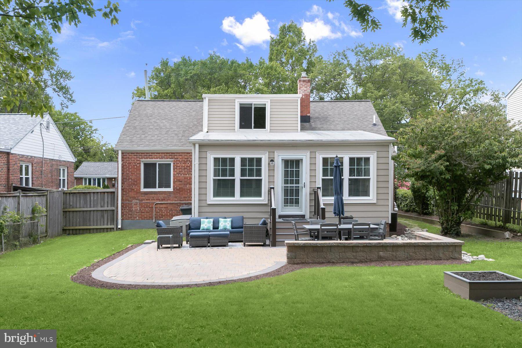 513 Gilmoure Drive Silver Spring, MD 20901 - Photo 58 of 60 a front view of a house with a yard table and chairs