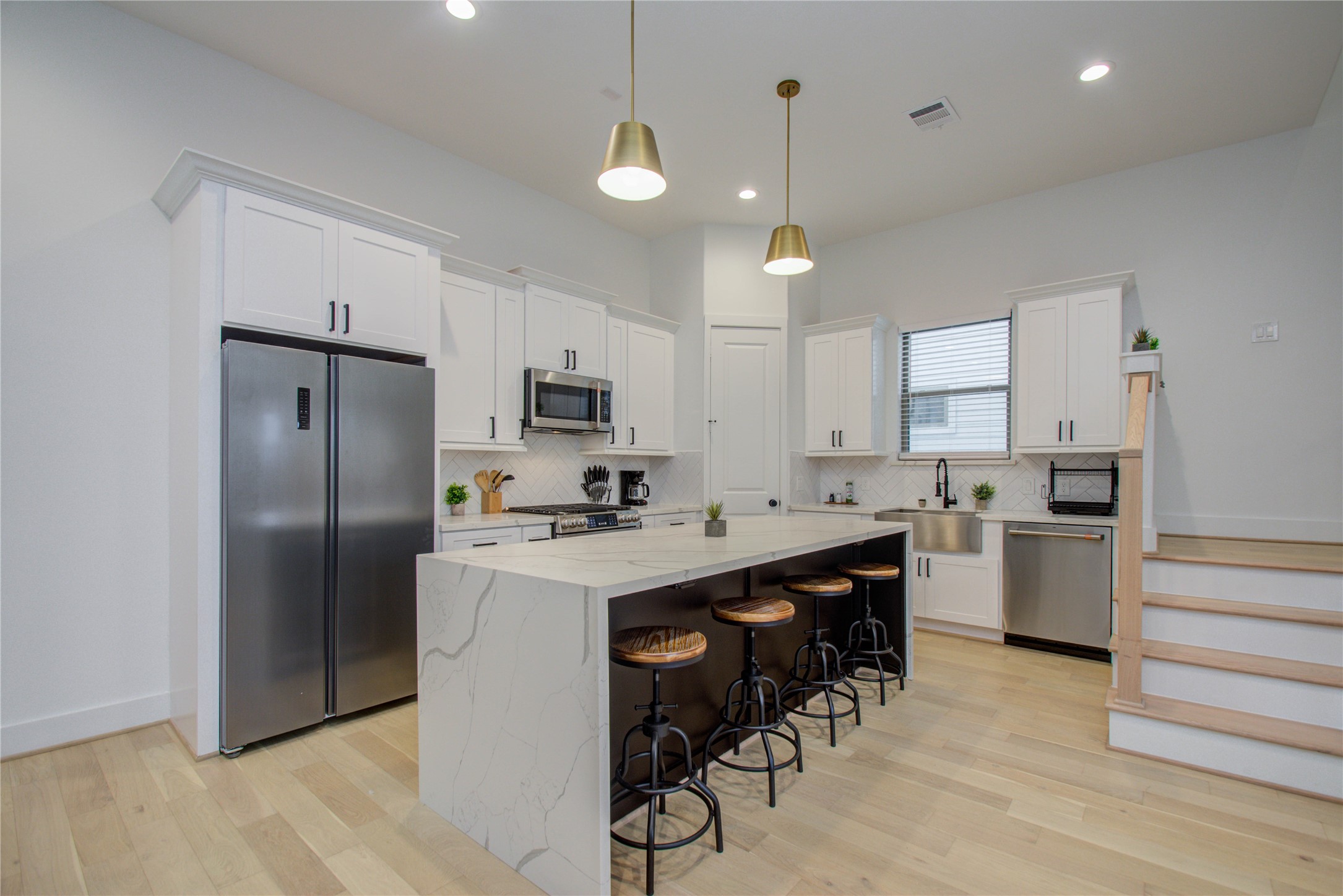 2315 Sherwin Street Houston, TX 77007 - Photo 14 of 50 a kitchen with refrigerator cabinets and wooden floor